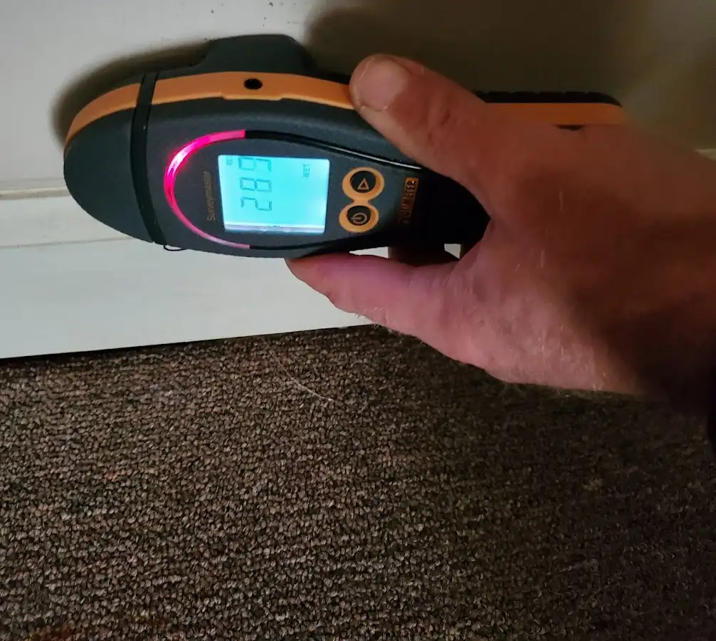 Moisture detection at baseboard during Storm Damage Restoration in Unity